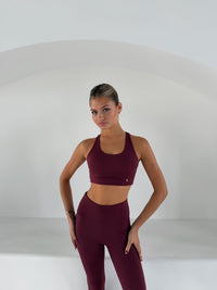 Breathe Sports Bra in Wine, racerback halter style, worn with matching high-waisted leggings