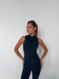 Navy Form 1/4 Zip Tank with mock neck, worn by woman in studio setting