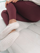 Pointe Ballerina Grip Socks in Bisque, worn on feet with burgundy leggings and white hoodie