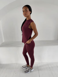 Flow Soft Tank in Wine, sleeveless top worn with matching wine leggings and grey trainers