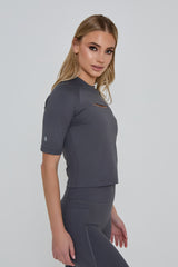 Model wears LIMITLESS FITTED TOP in grey