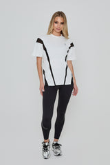 Model wears ACCELERATE OVERSIZED TEE in white