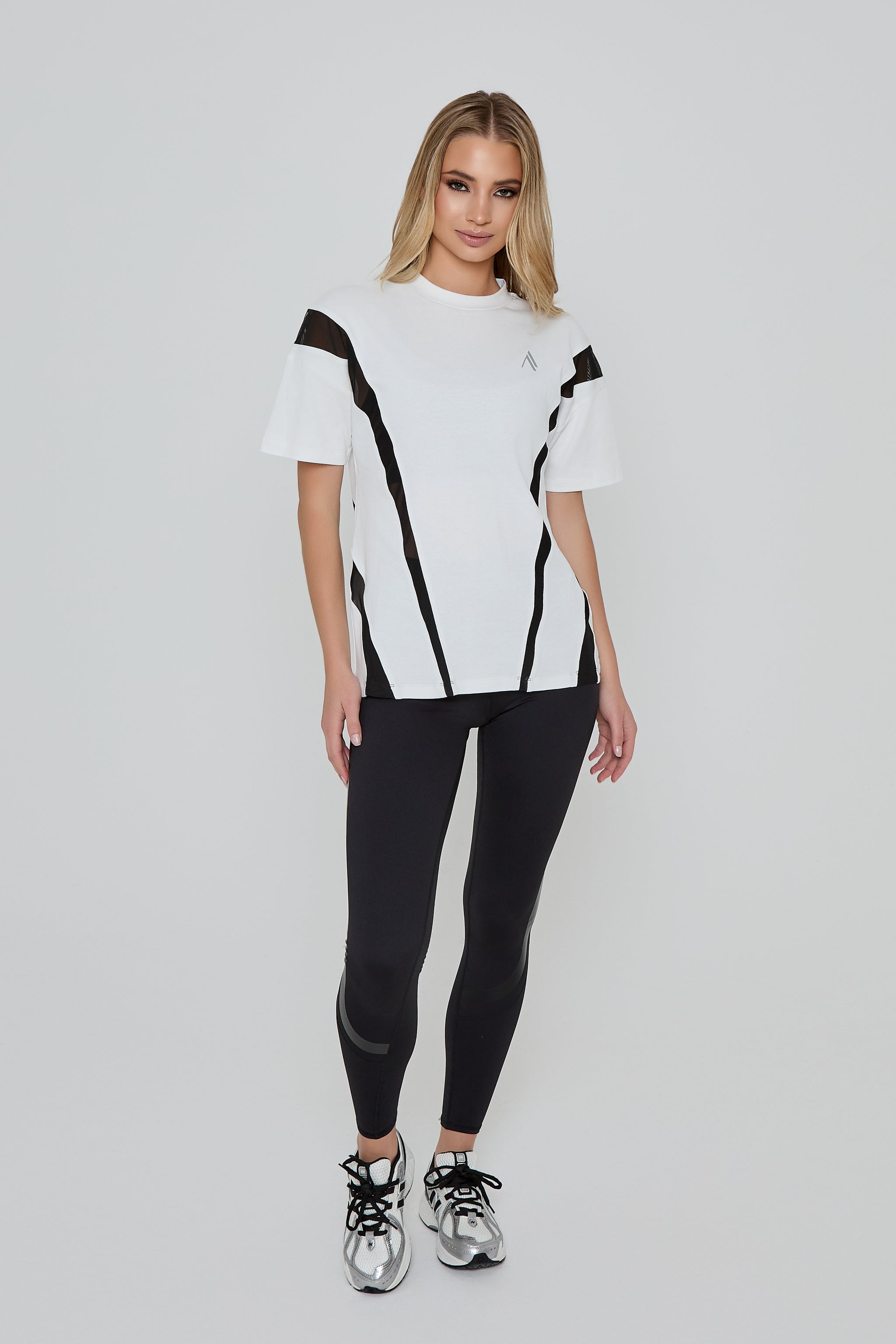 Model wearing DIRECTION LEGGINGS in black with ACCELERATE OVERSIZED TEE