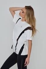 Model wears ACCELERATE OVERSIZED TEE in white