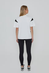 Model wears ACCELERATE OVERSIZED TEE in white