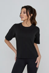 Model wearing REFINED TEE in black