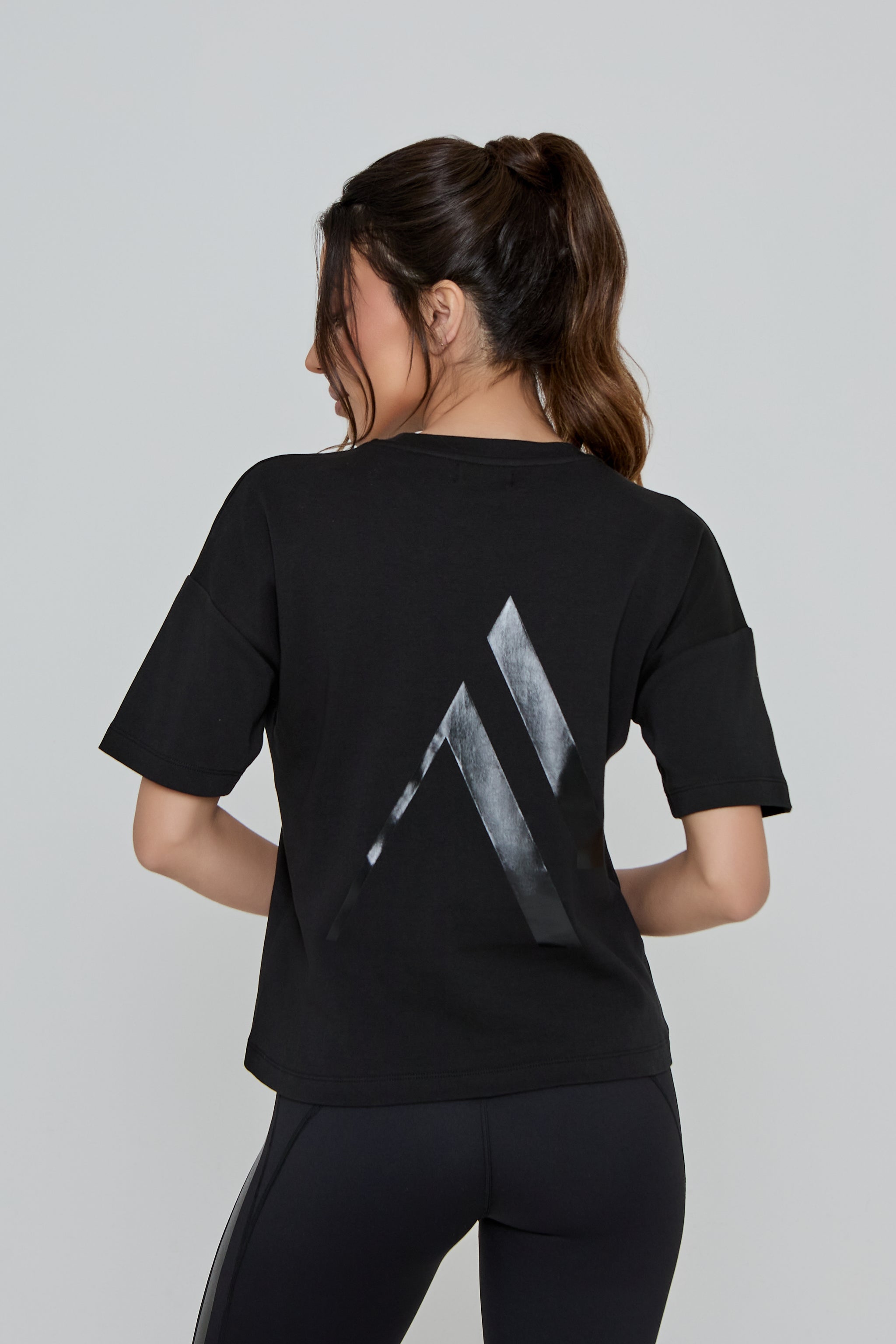 Model wearing REFINED TEE in black