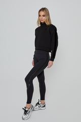 Model wearing DIRECTION LEGGINGS in black with IMPACT CROP SWEATSHIRT