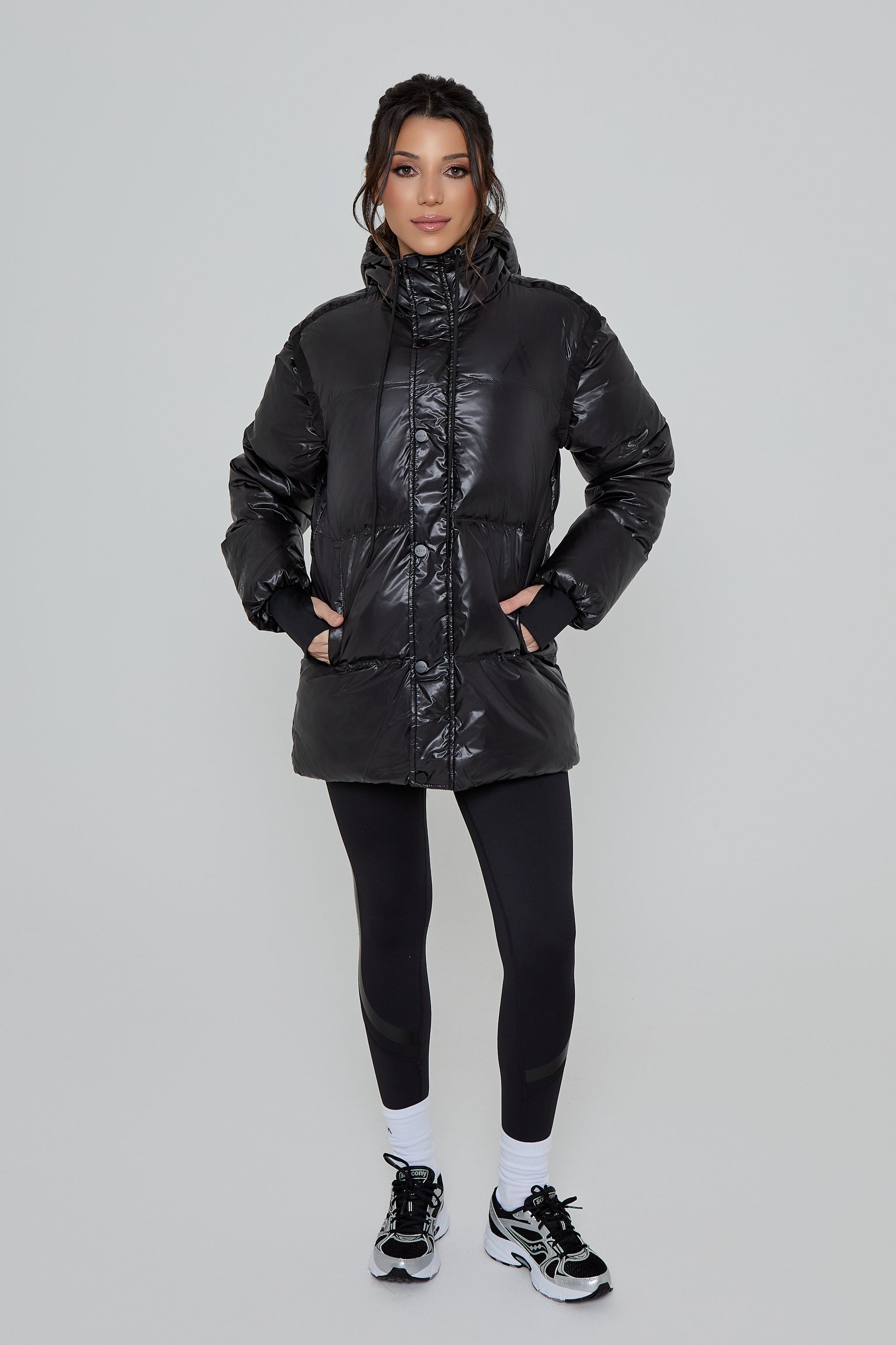 Model wearing DIRECTION LEGGINGS in black with DISCOVERY 2 IN 1 COAT 