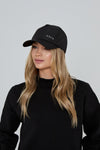 Model wears AGILITY SPORTS CAP in black with silver branding