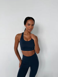 BREATHE Sports Bra in Navy, racerback design with removable cups, worn by model