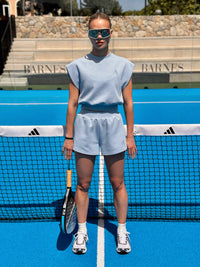 Cruise Sleeveless Sweat Top in Sky, worn on tennis court with matching shorts