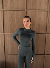Horizon Long Sleeve Top in Deep Forest, worn model showing fitted high-neck long-sleeve design with mesh panel detail.