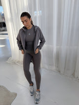 VELA HOOD JACKET in TRUFFLE, worn with matching leggings, styled with running shoes