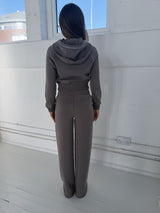 VELA Hood Jacket in Truffle, worn back view showing cropped silhouette and ribbed waist