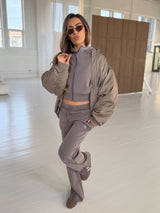 VELA Hood Jacket in Truffle worn with matching joggers, styled in a light indoor setting
