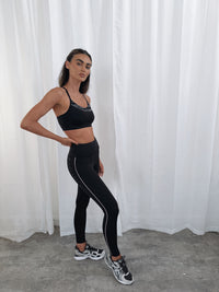 ENERGISE LEGGINGS in BLACK with reflective side stripe, worn with sports bra