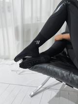 Core Pilates Socks in Black with grip sole, worn on feet