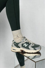 Cream cotton rib sock worn with New Balance sneaker, styled detail shot